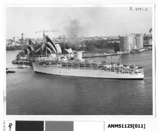 P&O passenger liner SS CHUSAN, being towed by a tugboat, passing Bennelong Point and the construction of  the Sydney Opera House.