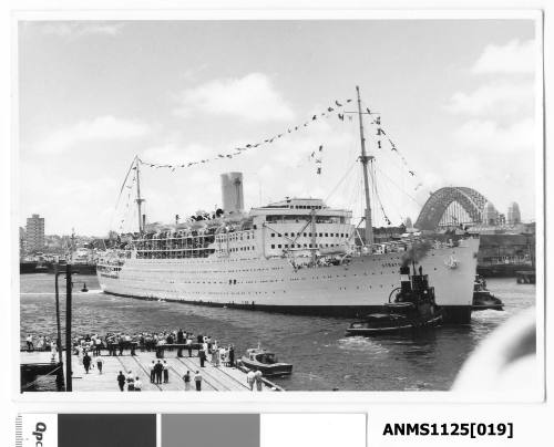 P&O passenger liner STRATHNAVER departing Sydney Harbour dressed with flags and pennants and farewelled by a large crowd on the wharf.