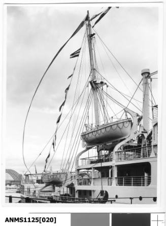 A starboard view of the stern mast of a passenger liner, most likely the P&O liners STRATHNAVER or STRATHAIRD, flying a long paying-off pennant.