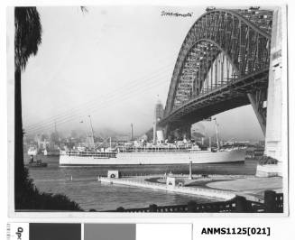 P&O liner STRATHMORE arriving in Sydney Harbour and passing under the Harbour Bridge with a tug boat following closely astern.