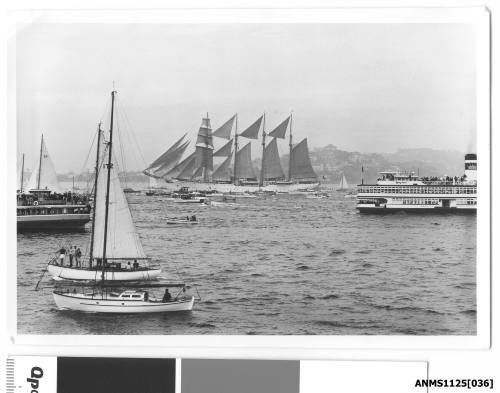 ESMERALDA, a four-masted barquentine training ship of the Chilean Navy, arriving in Sydney Harbour escorted by many small craft including the ferry the SYDNEY QUEEN.