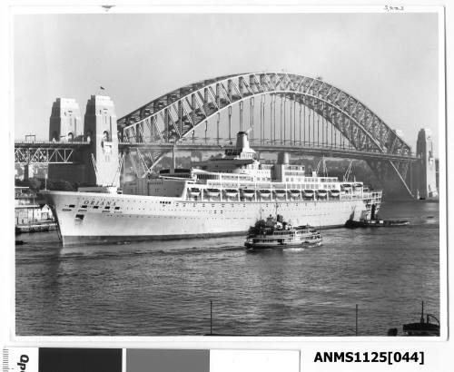 ORIANA, a twin funnel P&O passenger liner arriving at the International Terminal, Circular Quay. A tugboat is pushing at the starboard quarter.