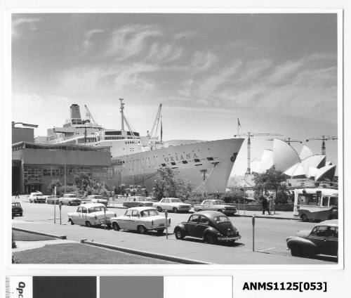 P&O liner ORIANA moored at Circular Quay with cars on Hickson Road & a Mr Whippy ice cream van in the foreground.