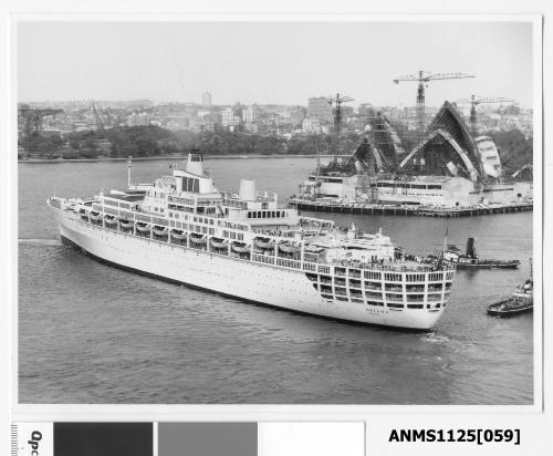 P&O liner ORIANA, outward bound with two tug boats assisting, passes the Sydney Opera House which is under construction.